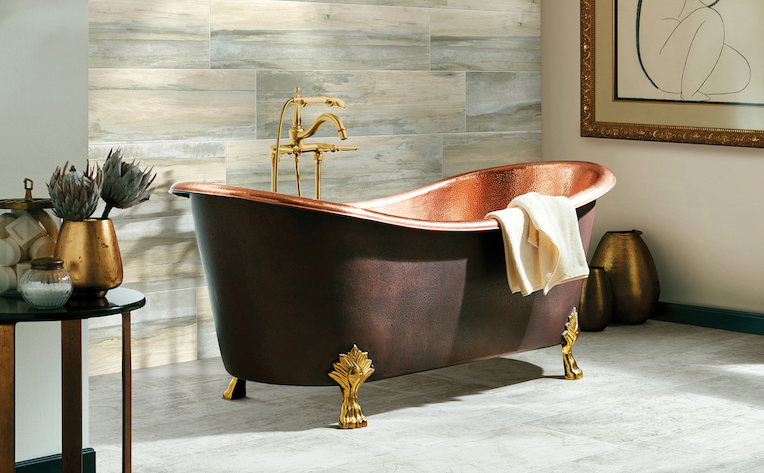 Bathroom remodeling idea with tile flooring, tile accent wall, and a beautiful freestanding copper tub